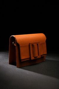 brown leather handbag on a black surface