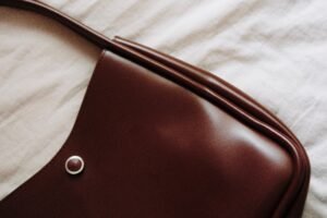 brown leather handbag on a soft fabric background