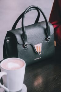 Best Everyday Handbags black leather everyday handbag on a cafe table